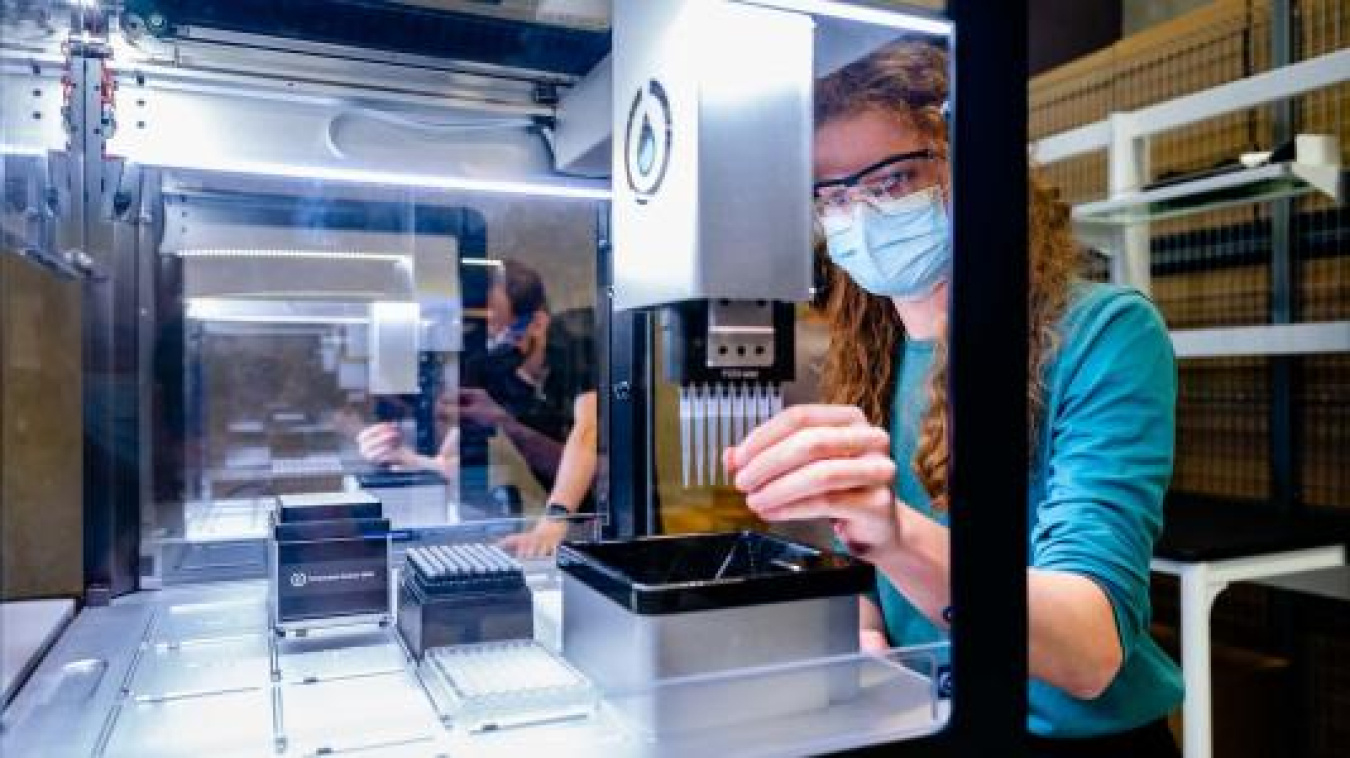Casey Stone prepares to test a pipetting robot.