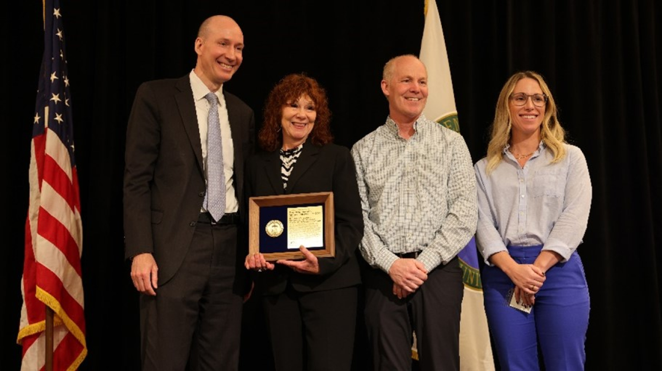 Deputy Energy Secretary David Turk, from left, presents the DOE Project Management Achievement Award for the Tank-Side Cesium Removal System (TSCR) project to Janet Diediker, federal project director, TSCR Demonstration Project, Tank Farms Project; Paul Schroder, deputy assistant manager, Tank Farms Project; and Vanessa Turner, director, Tank Farms Business Operations Division, Tank Farms Project.