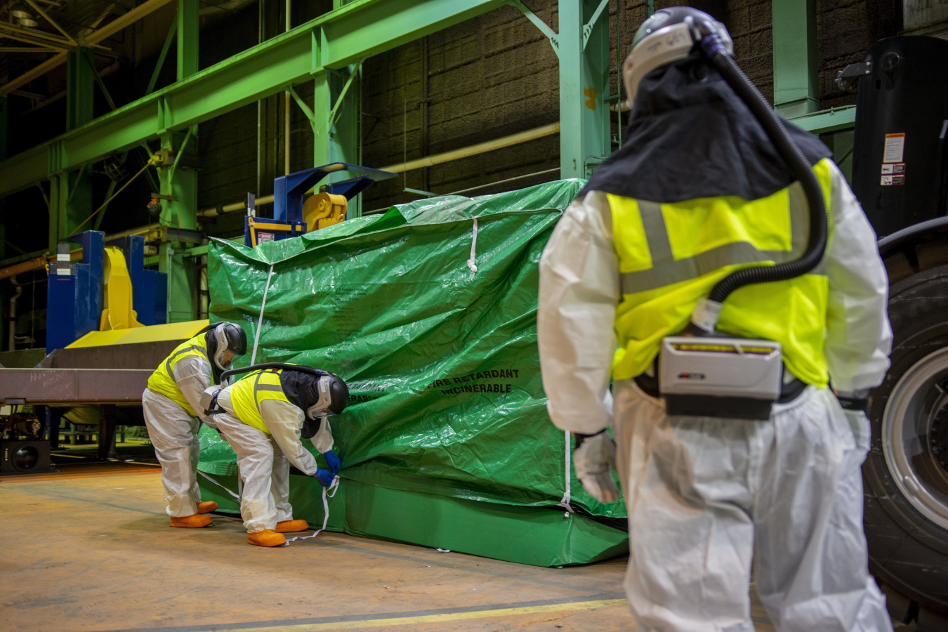 Paducah Site crews complete a demonstration wrapping a surrogate bundle in the bundle compaction area. The surrogates were used to simulate the size and makeup of an actual converter bundle.