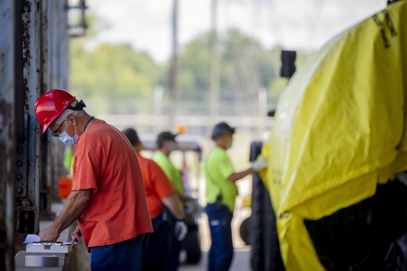 Conduct of Operations Specialist Tony Threatt checks the procedure for transporting bundles from the C-333 Process Building to the bundle compaction area.