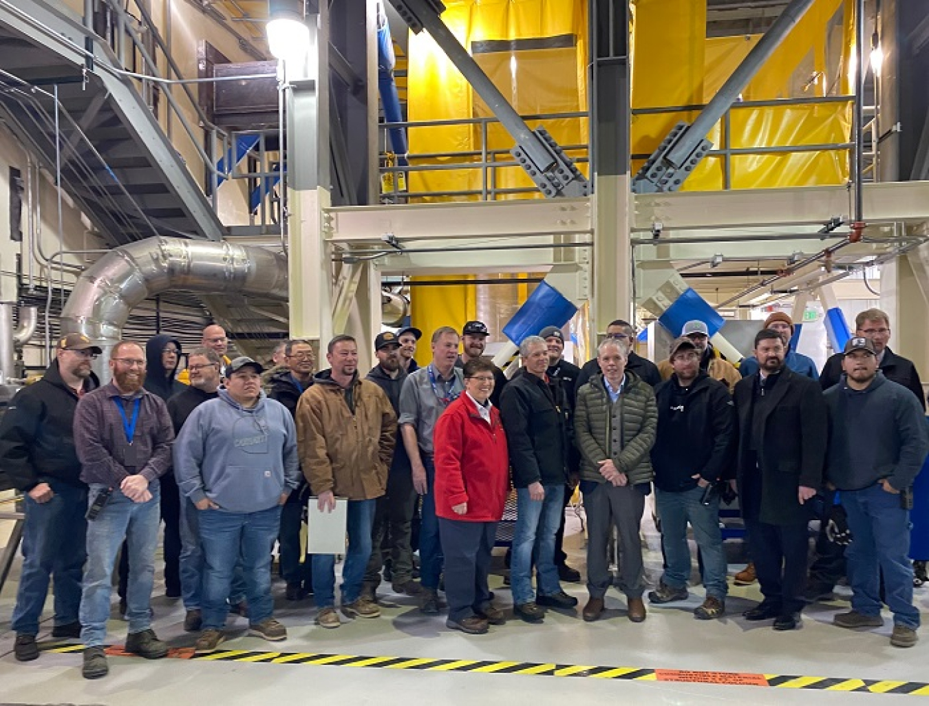 EM Senior Advisor William "Ike" White and Idaho Cleanup Project Manager Connie Flohr, at center, thank Integrated Waste Treatment Unit staff at the Idaho National Laboratory Site in late March as they prepared for the start of radiological operations that will convert 900,000 gallons of sodium-bearing liquid waste to a dried, granular solid. EM Principal Deputy Assistant Secretary Jeff Avery is also pictured, front row, second from far right.