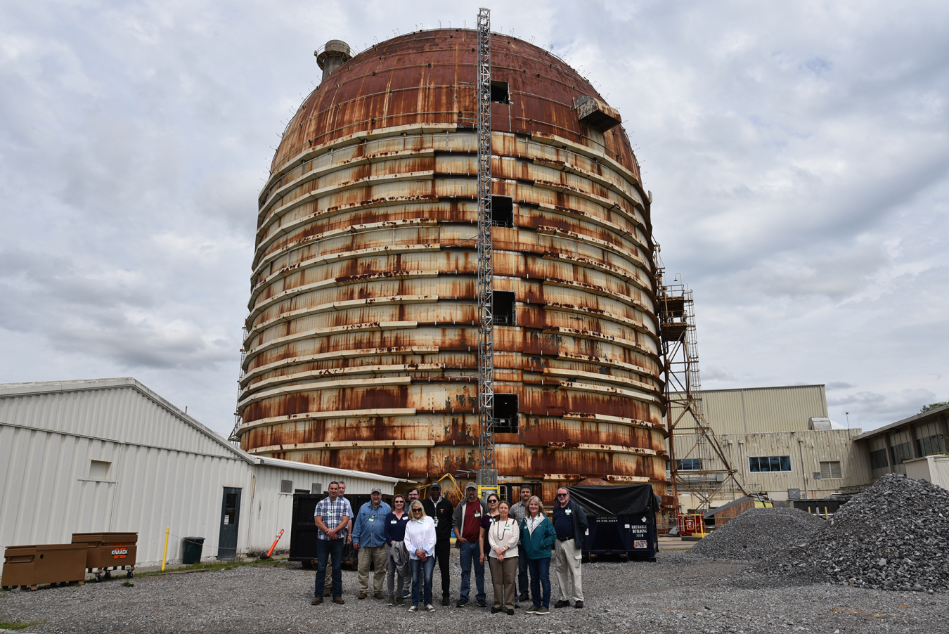 New members of the Oak Ridge Site Specific Advisory Board toured major cleanup projects across the Oak Ridge Reservation during their recent orientation. They are pictured next to the Experimental Gas Cooled Reactor at Oak Ridge National Laboratory, where deactivation efforts are underway. Oak Ridge Office of Environmental Management Regulatory Affairs Specialist Roger Petrie is also pictured at far left in the background. 