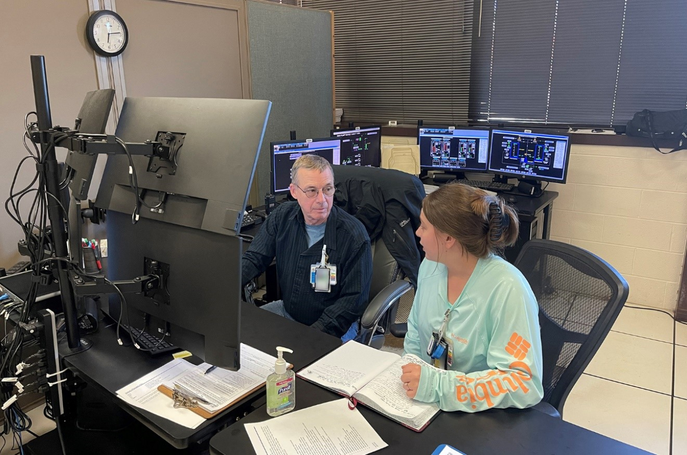 Joe Kuykendall, left, instructs Alyssa Piece on a new system at Liquid Gaseous Waste Operations, which supports waste treatment at Oak Ridge National Laboratory.