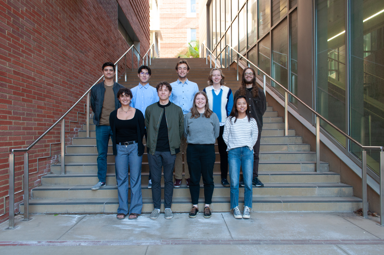Two rows of students standing on an outdoor staircase.