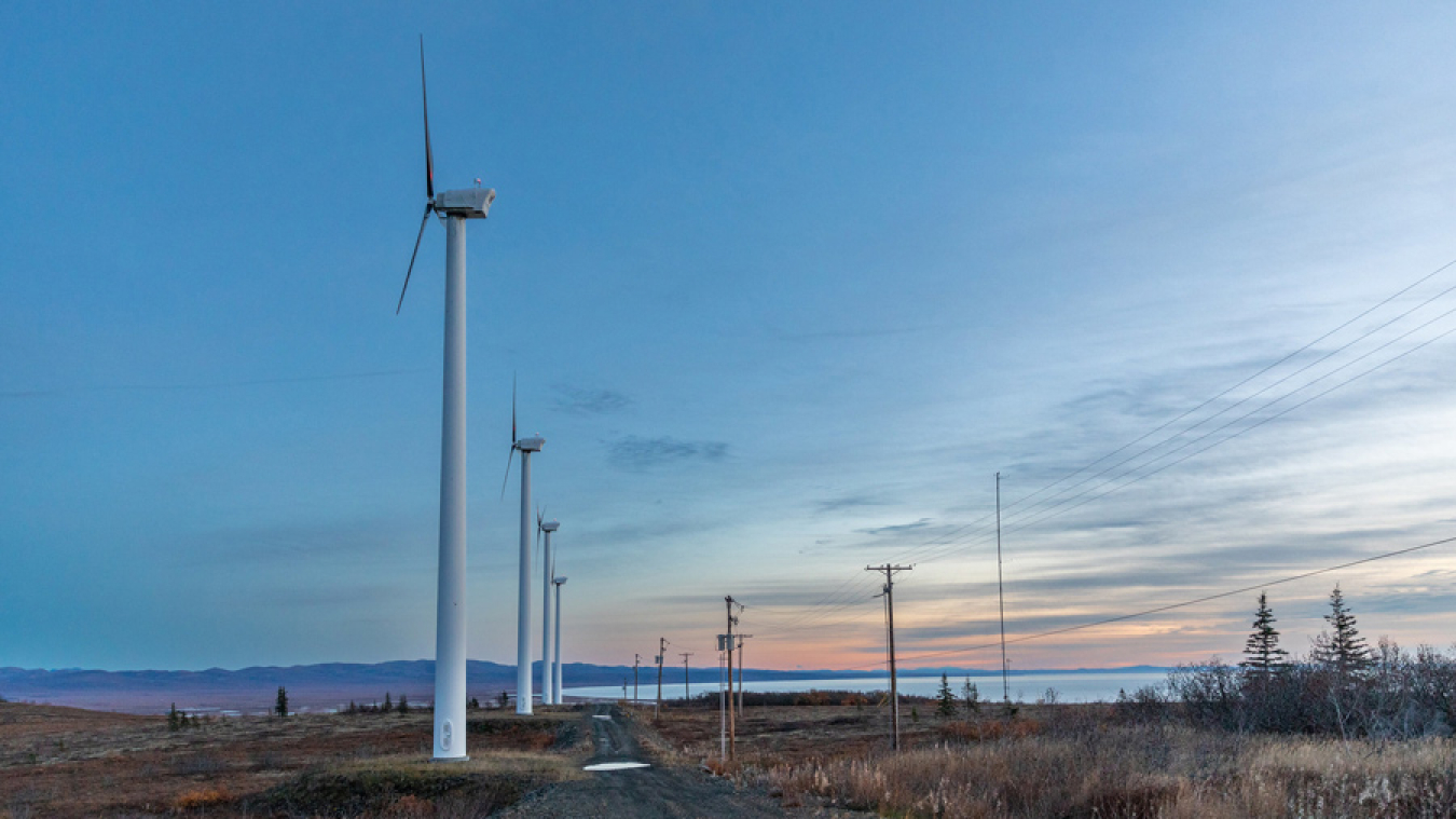 Several wind turbines at twilight in remote Alaska.