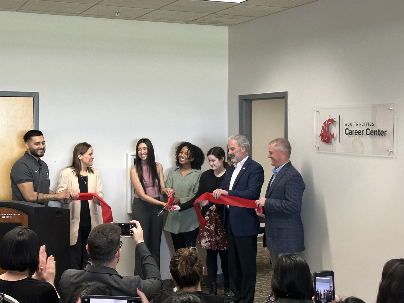 From left, John Navarro, Washington State University (WSU) Tri-Cities Career Center, Sandra Haynes, WSU Tri-Cities chancellor, WSU Career Center staff, John Eschenberg, Central Plateau Cleanup Company president and CEO, and Wes Bryan, Washington River Protection Solutions president and project manager, cut a ribbon at the new WSU Tri-Cities Career Center. 