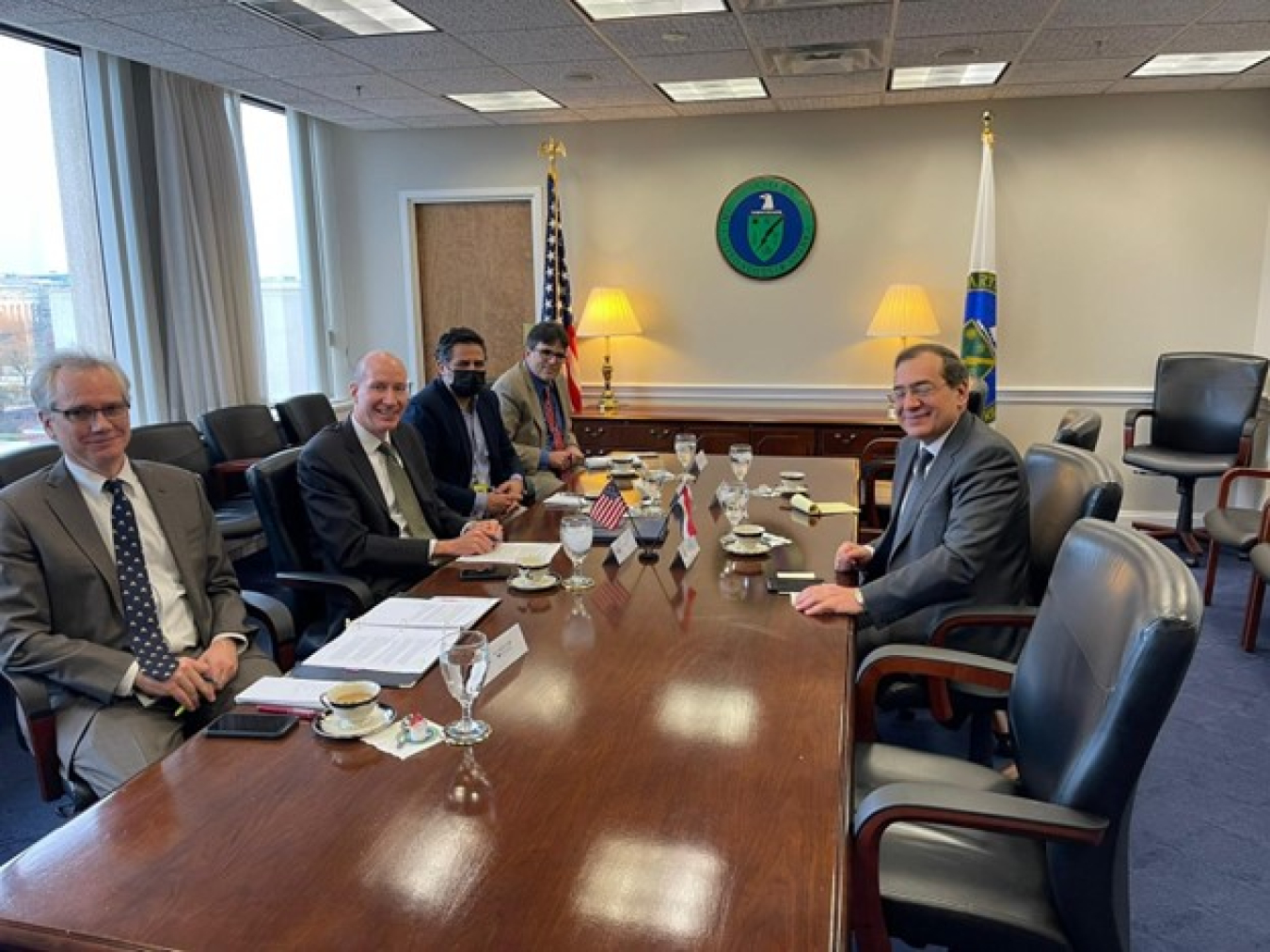U.S. Deputy Secretary of Energy David Turk, other Department officials, and Egypt’s Minister of Petroleum Tarek El Molla sit at a table in a conference room during a meeting.