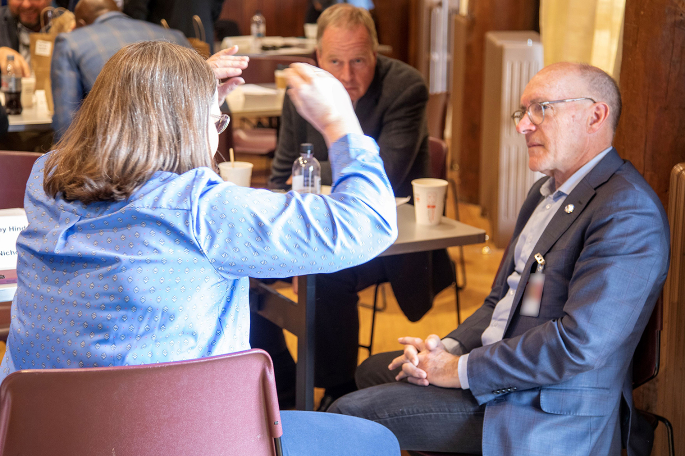 Ambassador Holgate gestures with her hands while talking to Dr. Robert Floyd in Los Alamos.