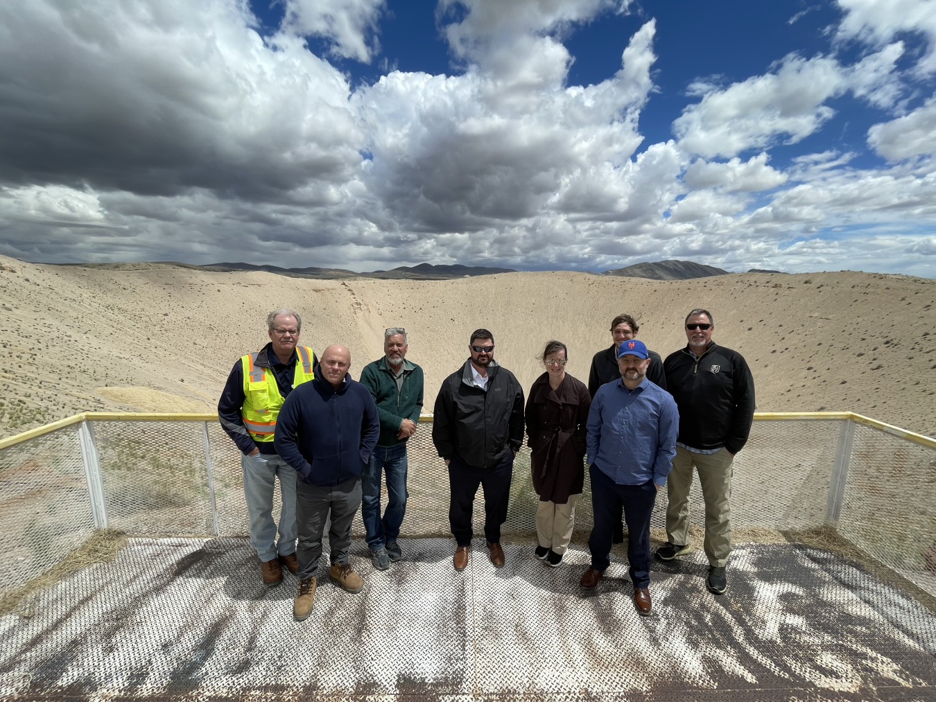EM leaders Jeff Avery and Kristen Ellis are pictured at center on a tour of Sedan Crater, which was formed in 1962 when the U.S. Atomic Energy Commission, a predecessor agency to DOE, conducted an excavation experiment using a 104-kiloton thermonuclear device. The test, detonated 635 feet underground, helped develop technology for earth-moving projects.