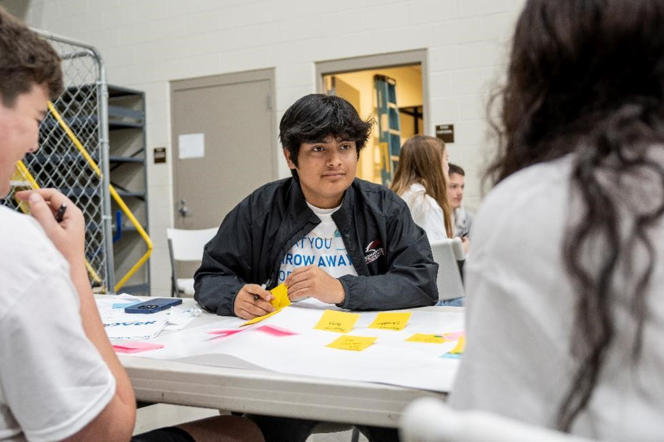 AJ Ragan of McCracken County High School works with his ECOThink team to brainstorm ideas that the nonprofit Empowered Solutions for Environmental Sustainability can apply to managing plastic waste around the world.