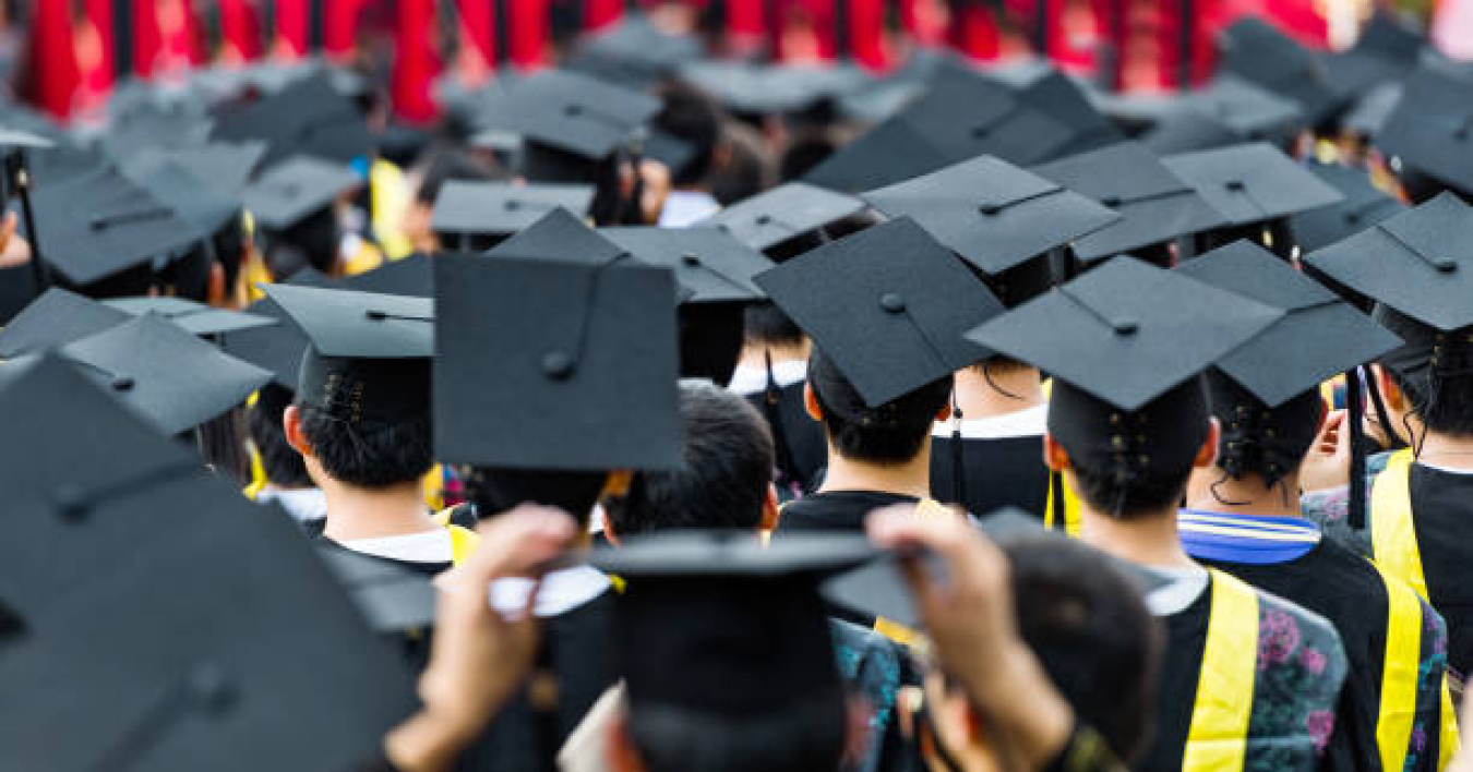 Photo of sea of graduates with caps