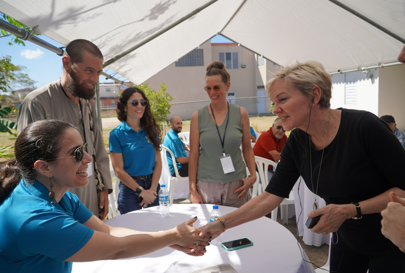 Secretary Granholm greets members of Barrio Eléctrico at a solar and storage system tour in Isabela.