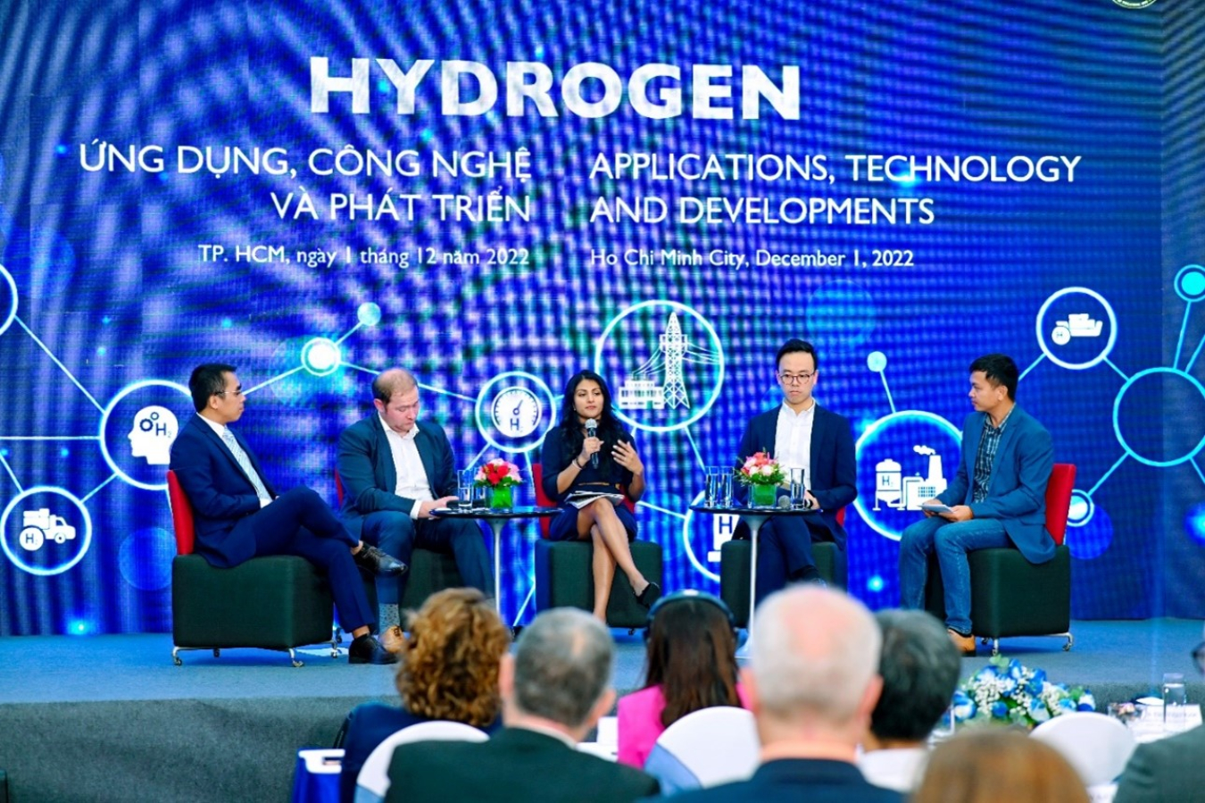 United States Department of Energy representatives sit on a stage with other participants during a panel discussion at a hydrogen applications workshop in Ho Chi Minh City, Vietnam.