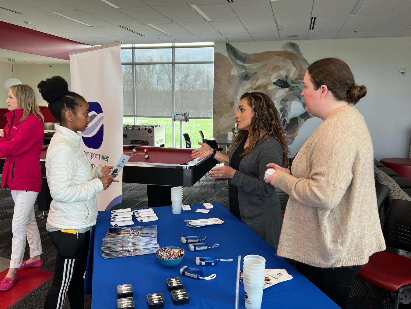 A Washington State University Tri-Cities student, left, chats with Haydee Ramirez and Timmary Staigle with Washington River Protection Solutions Workforce Resources about internship and career opportunities during a student-and-recruiter event at the campus student union building earlier this month.