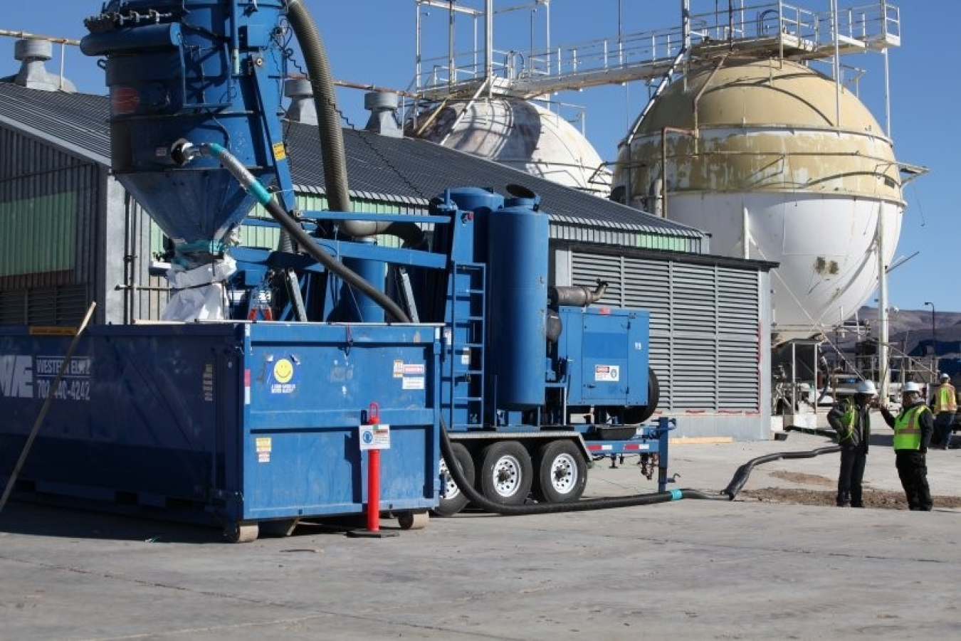 Perlite is extracted via a vacuum and hose system from one of the dewars at Test Cell C
