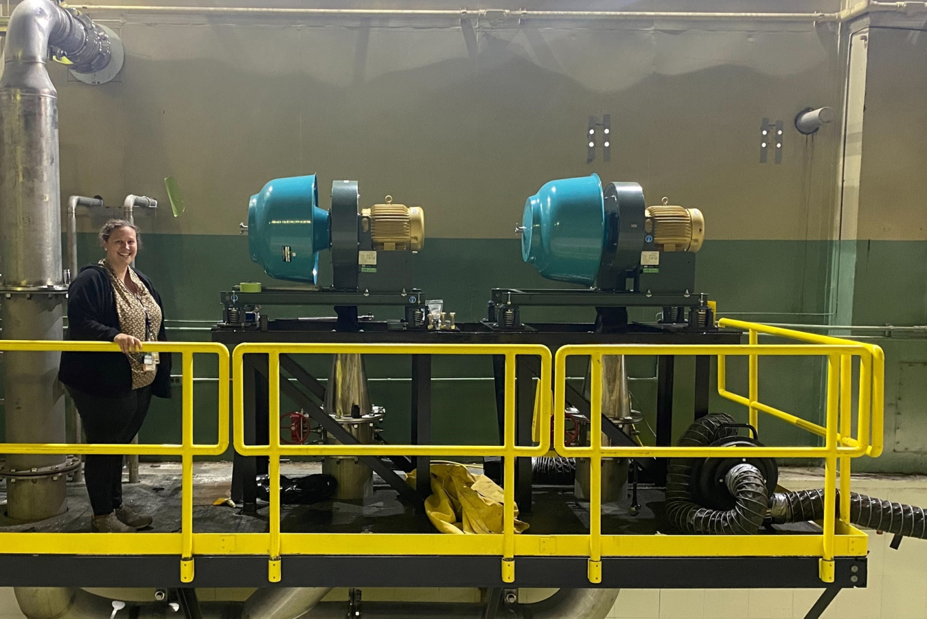 Avery Newman, a chemical engineering major from Tennessee Tech University, is pictured with newly installed blowers for the Continuous Purge System at the Molten Salt Reactor Experiment facility at Oak Ridge National Laboratory.