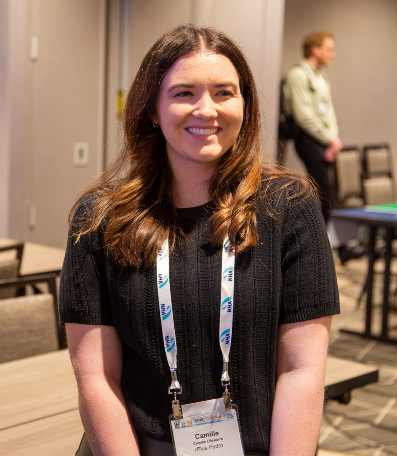 Camille Ellsworth smiling while wearing a name tag.