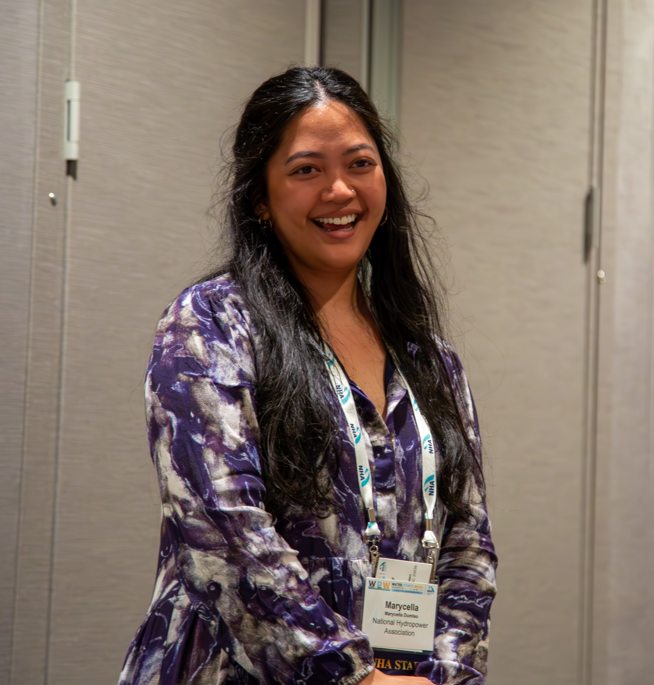 Marycella Dumlao smiling and wearing an name badge.
