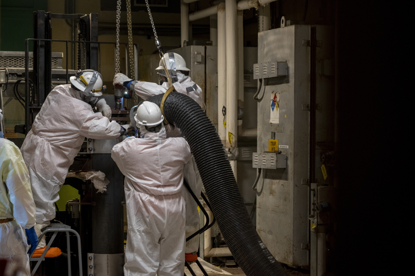 Paducah Site deactivation crews use negative air machines to open sodium fluoride traps. The team removed the trap’s head, which had to be replaced with a fitting for the safe shipment of the equipment.