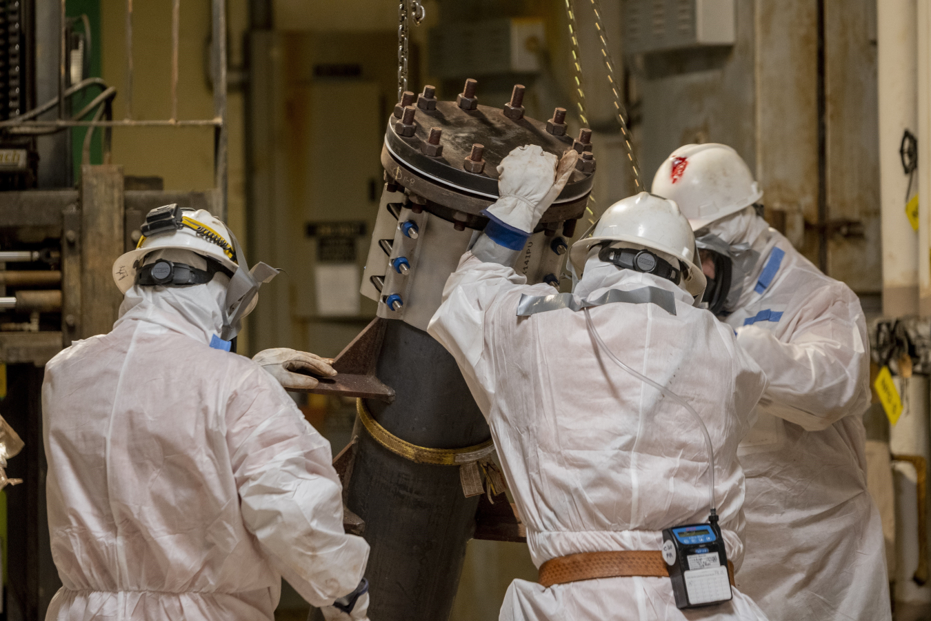 Deactivation crews at the Paducah Site hoist a sodium fluoride trap prepared for packaging and shipment.