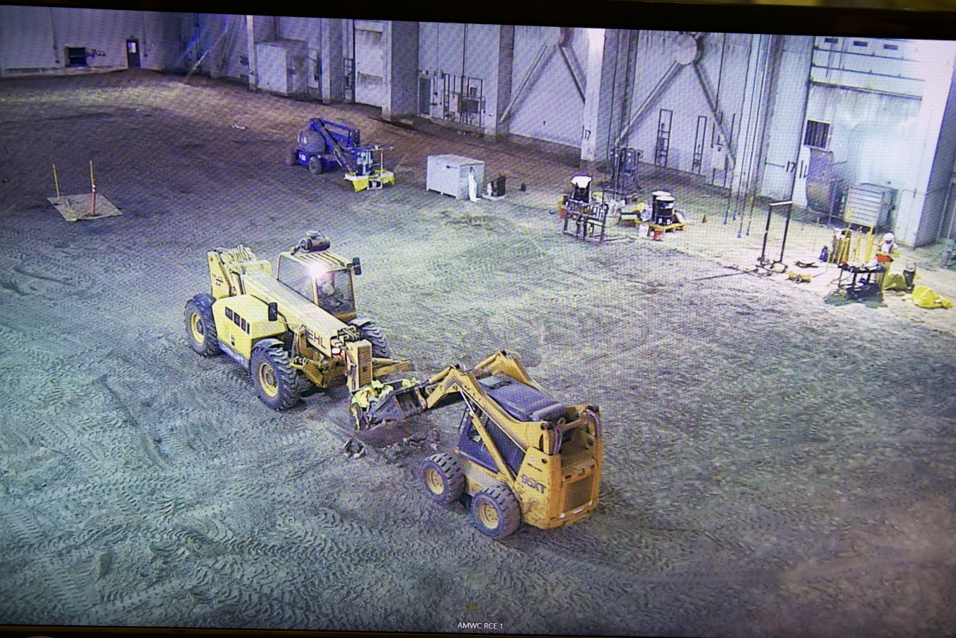 EM crews use light construction equipment to remove the final pieces of asphalt from one of the pads at the Transuranic Storage Area-Retrieval Enclosure, which once housed thousands of barrels and boxes of waste.
