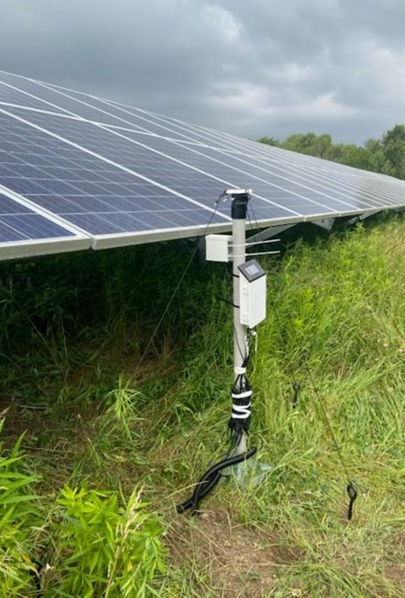 Field testing equipment monitors underground soil moisture at a New York solar facility.