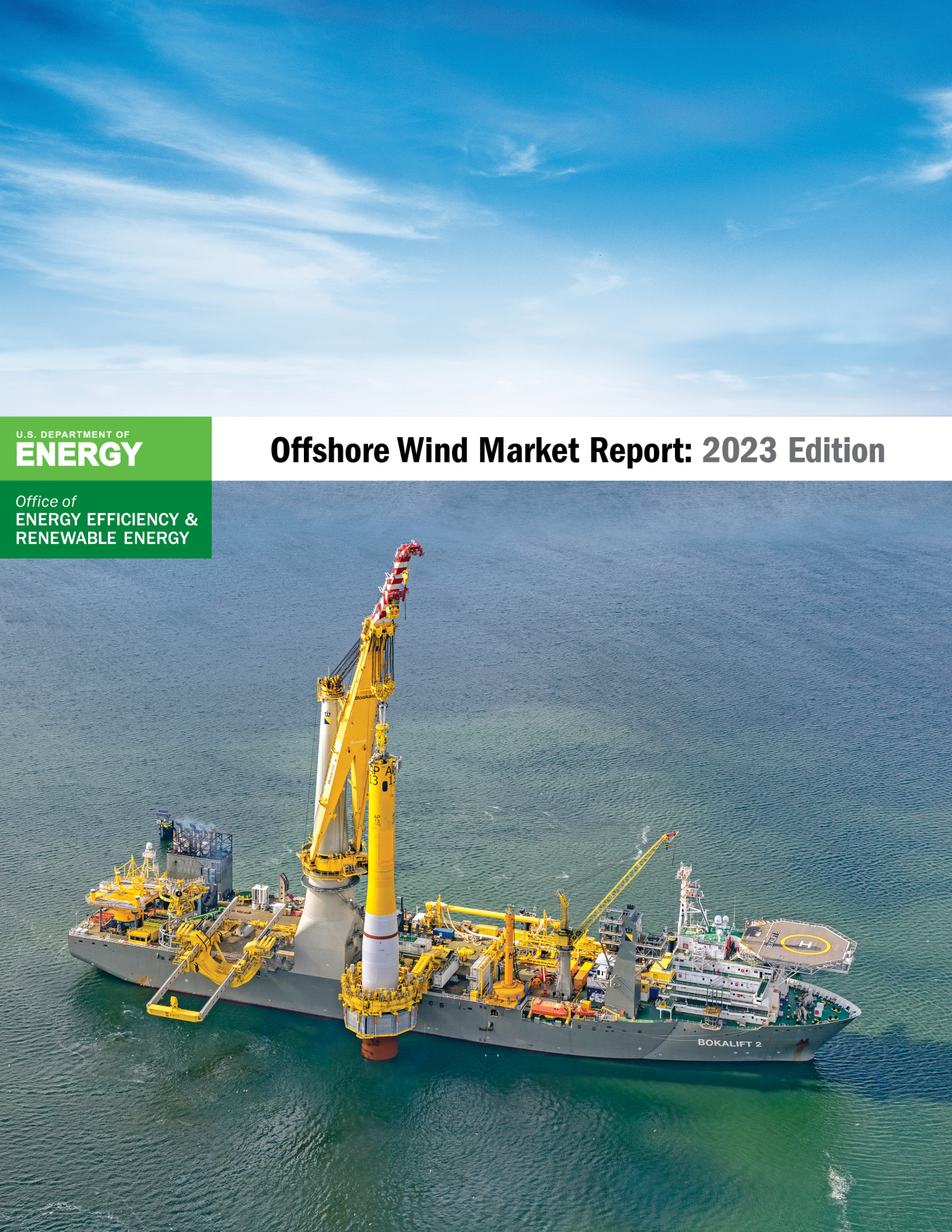 A photo of a barge carrying wind turbine equipment overlain by the U.S. Department of Energy Wind Energy Technologies Office logo and the title Offshore Wind Market Report: 2023 Edition