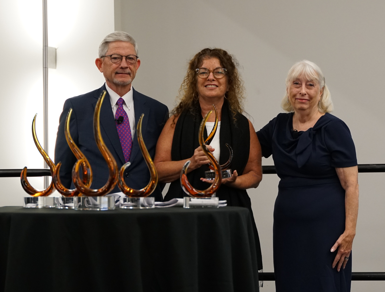 LM Beneficial Reuse Asset Manager Diana Kamenel Trettin (center) accepts the 2023 Phoenix Award from Phoenix Awards Institute members Lloyd Kirk (left), and Linda Garczynski.