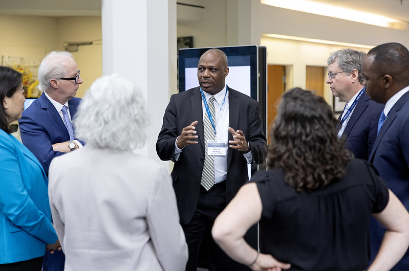 Dr. Henry McKoy meeting with people in August 2023