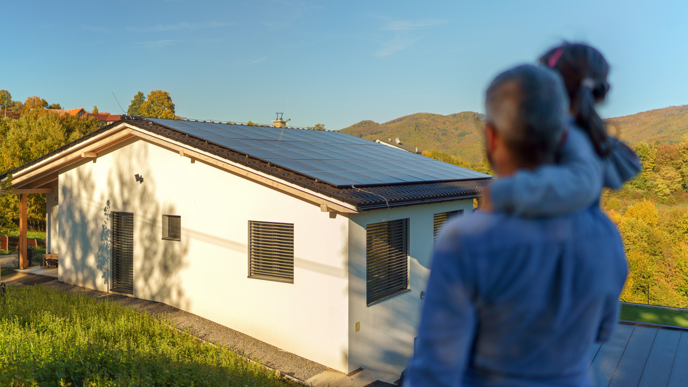 family looking at solar paneled roof