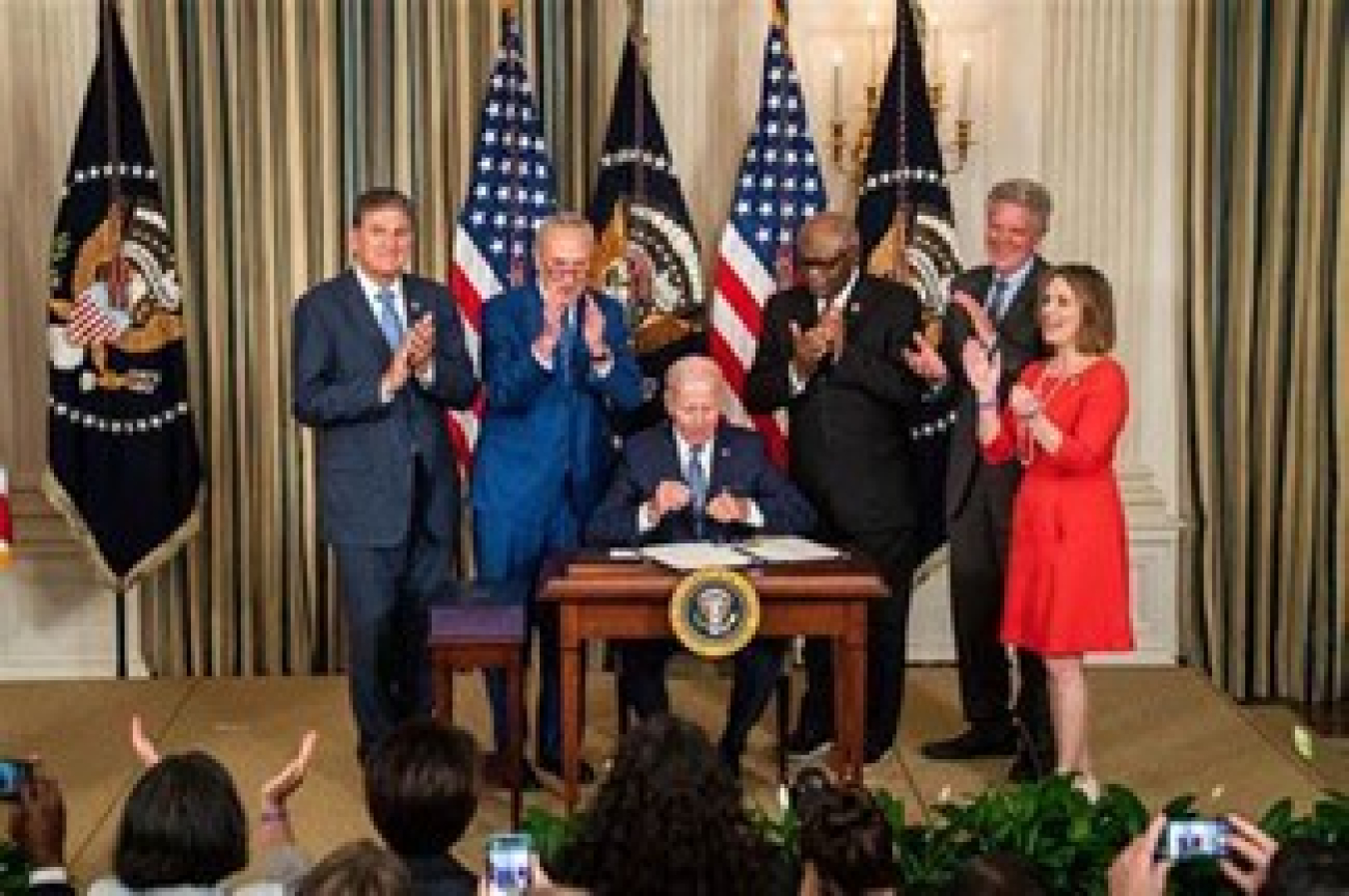 Dr. Henry McKoy, center right, stands next to Joe Biden and others at a signing ceremony at the White House.
