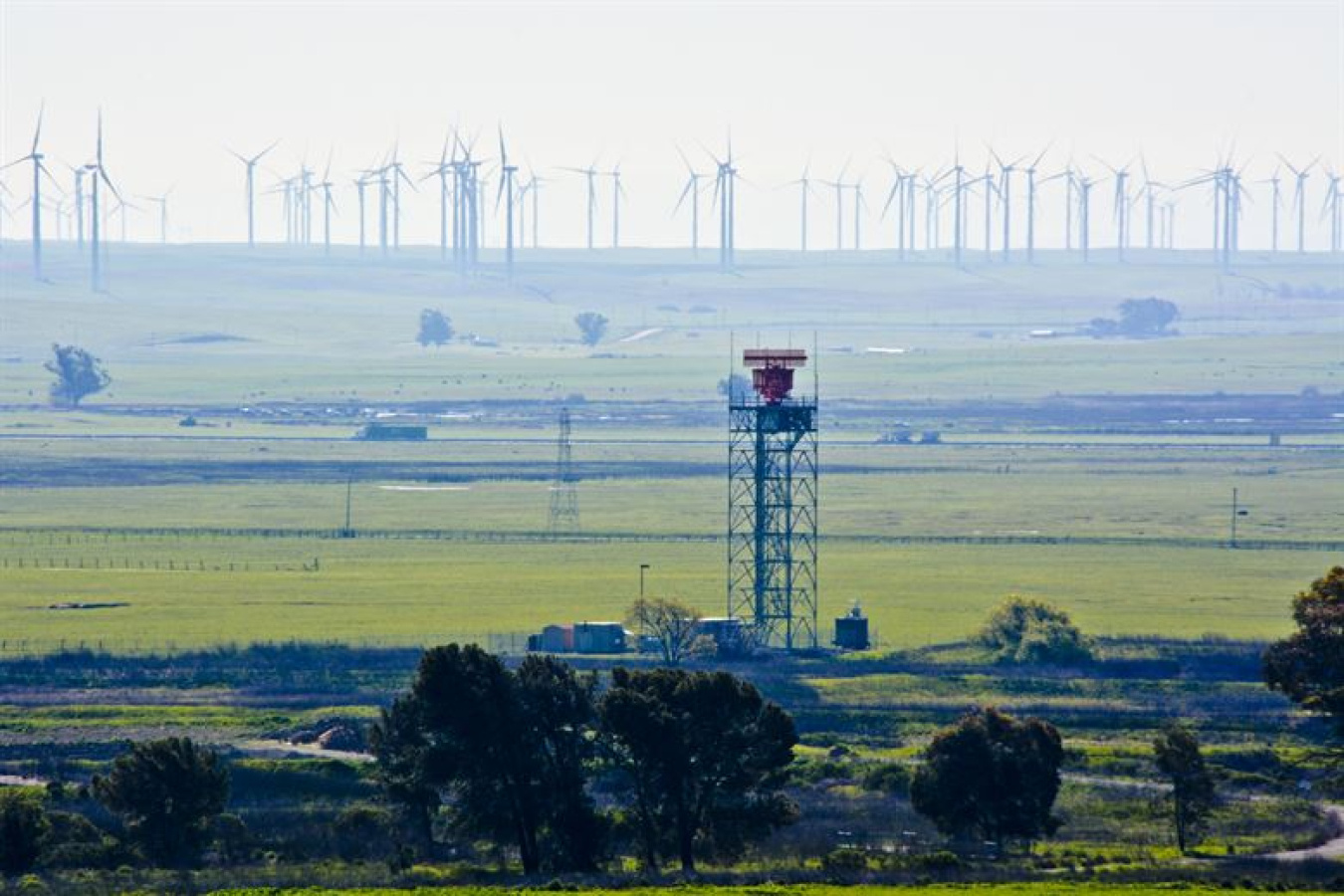 Wind turbines and a radar tower. 