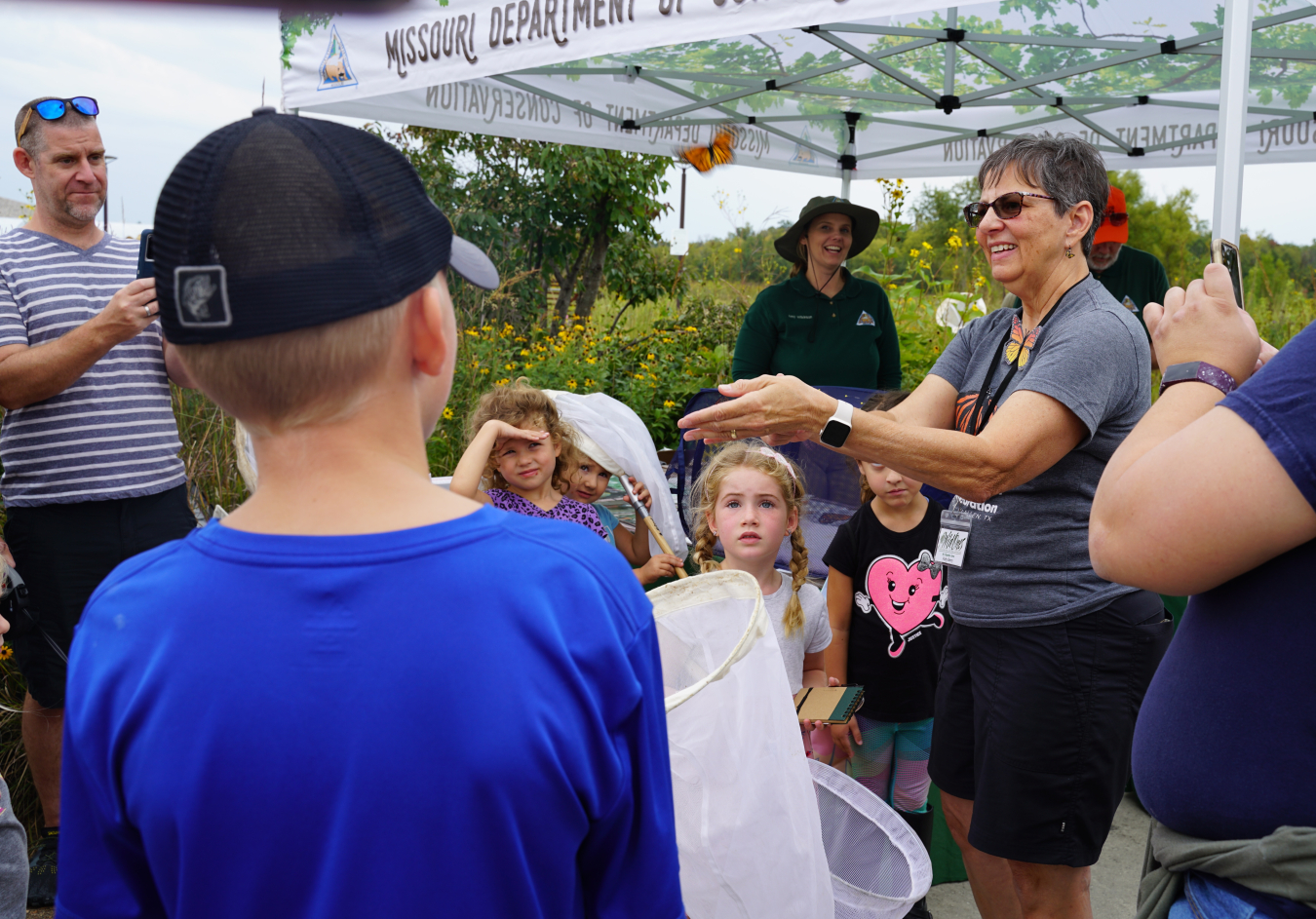 Patty Berry, vice president of Wild Ones for the St. Charles and Surrounding Areas chapter, releases a male monarch butterfly in the garden, after tagging it.