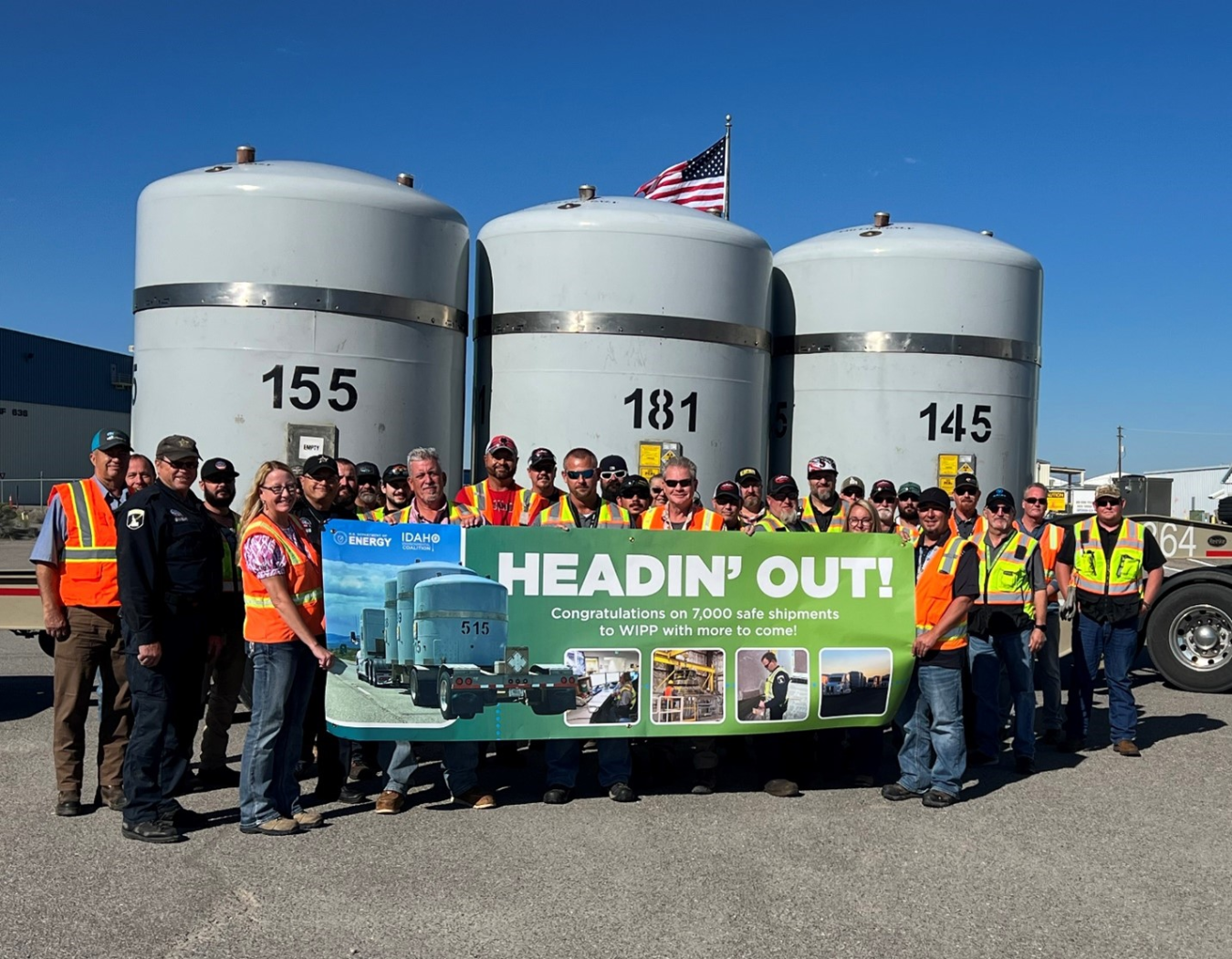 EM crews pose in front of banner