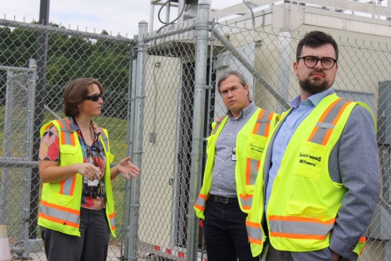 Site supervisor explaining air monitors in background