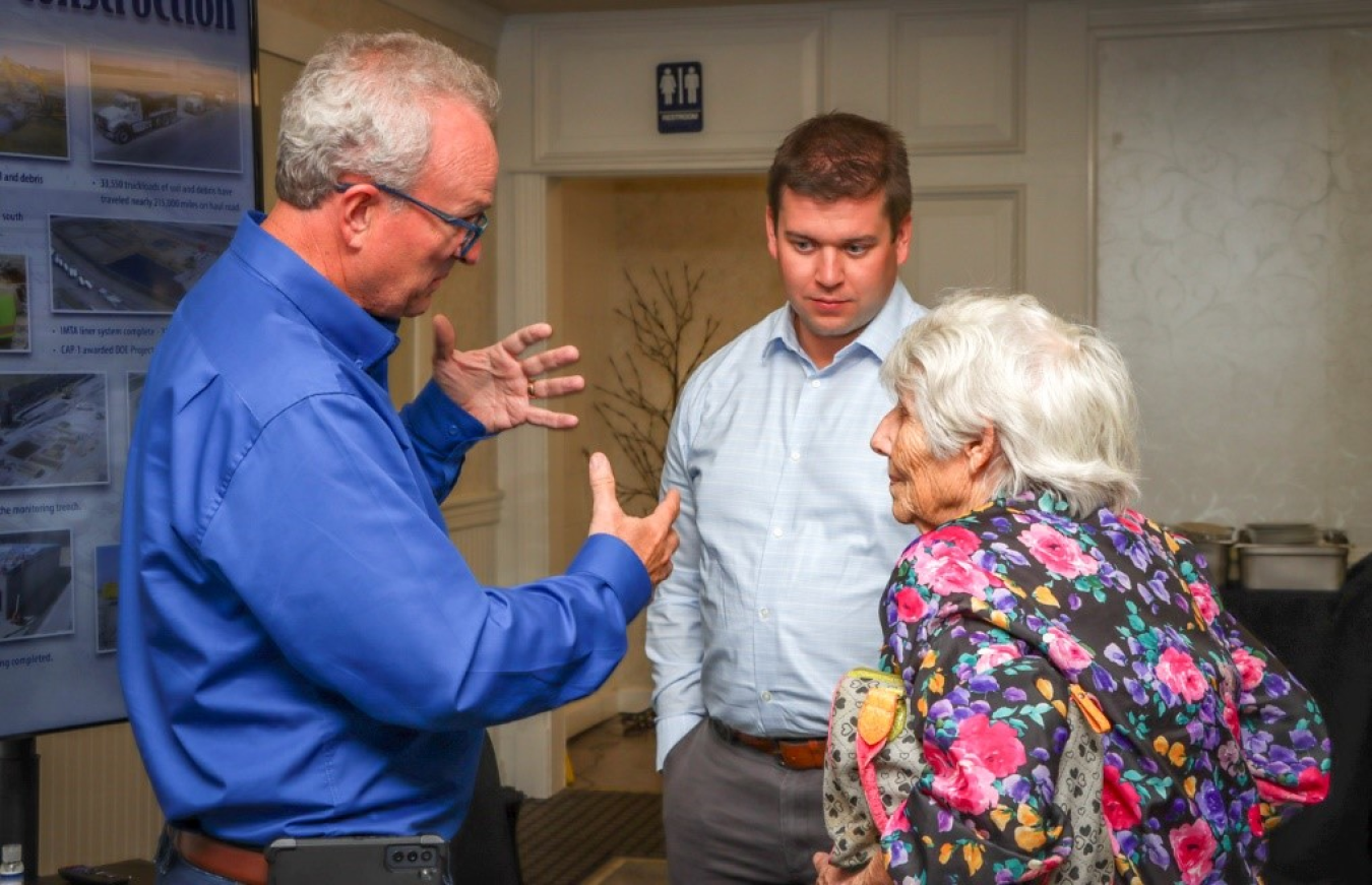 Three people speaking at a poster session at the Pike County Open House