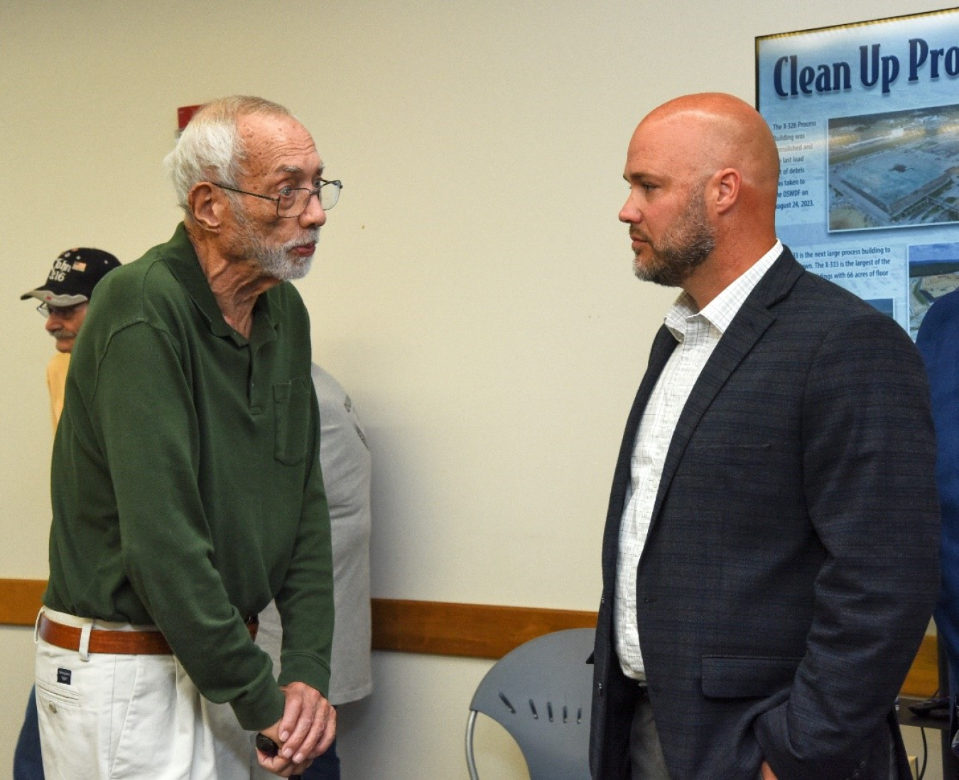 Two men speaking at the open house