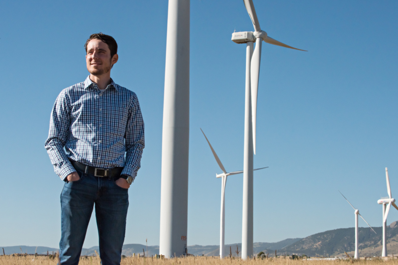 Eric Lantz standing among wind turbines