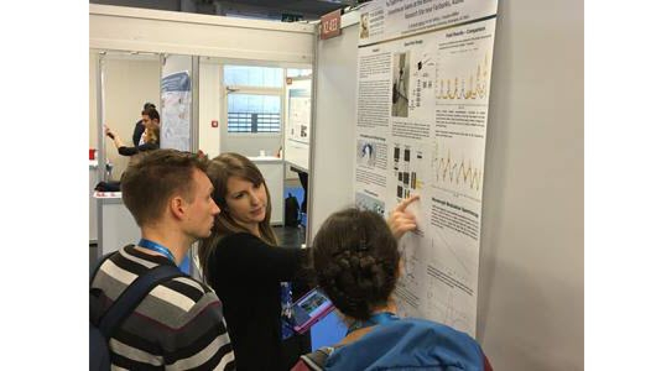Young woman (Michelle Bailey) presenting a poster at a conference