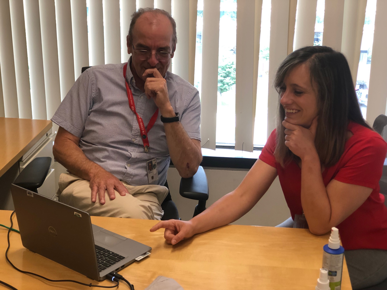 Two people looking at a laptop together