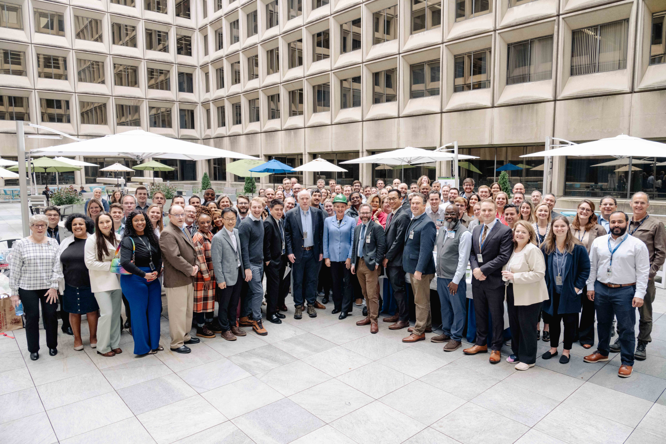 A group of people standing in an outdoor courtyard.