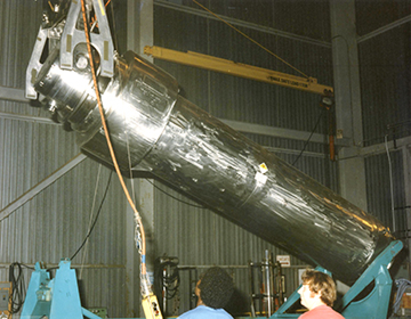 Raising a fuel cask into position using the Building 22 bridge crane. The vaults in Building 22 were used for the storage for nuclear fuel. Photo dated August, 1987.