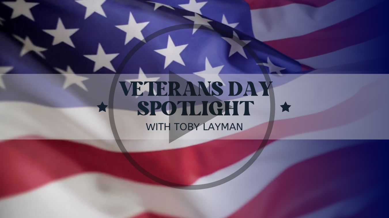 US Flag with Veterans Day Spotlight with Toby Layman linked to YouTube Interview