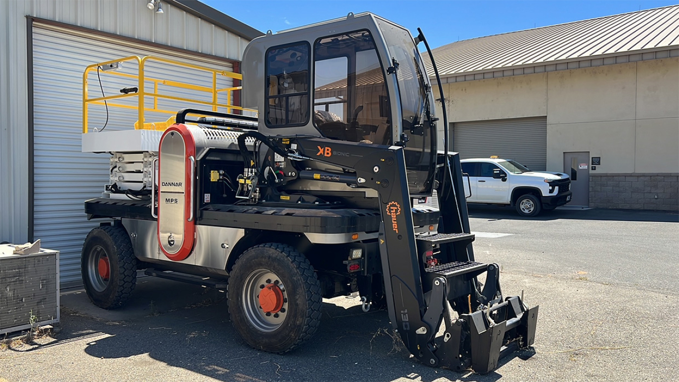 Vehicle with forklift and scissor lift attachments.