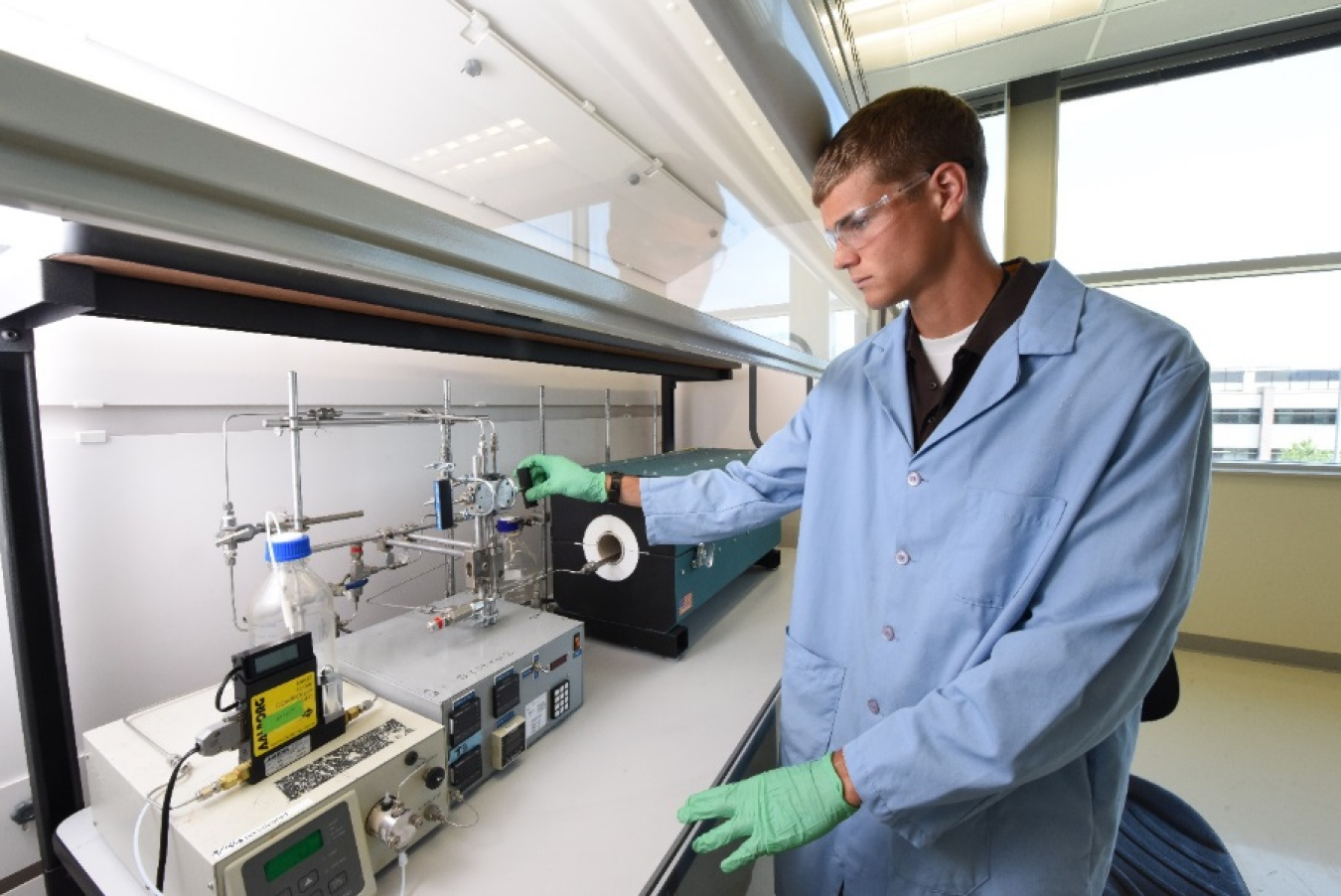 Scientist wearing personal protective equipment in a laboratory.