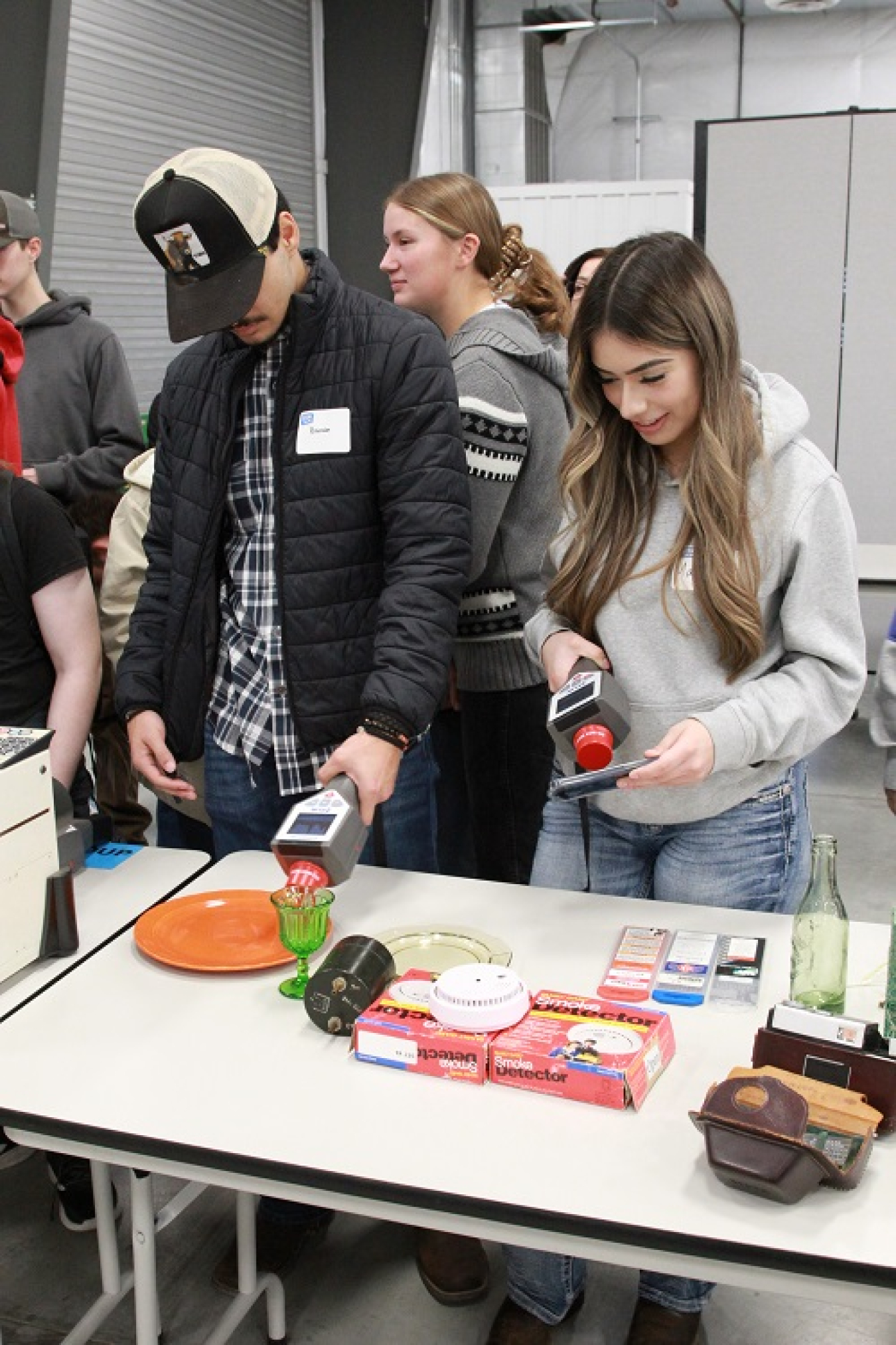 Students stand around a table and use radiation detection equipment
