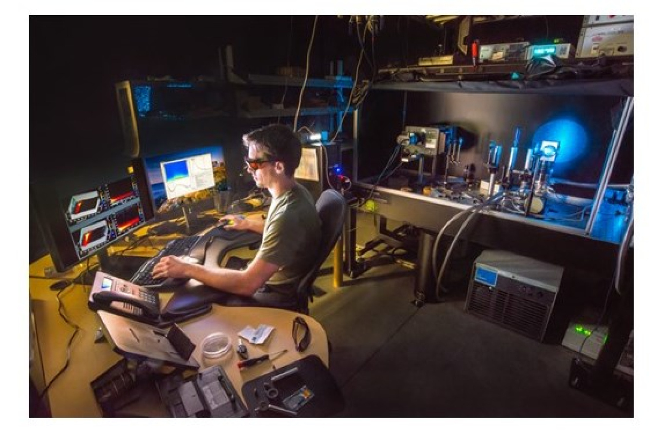 A person sitting at a desk viewing data on his computer.