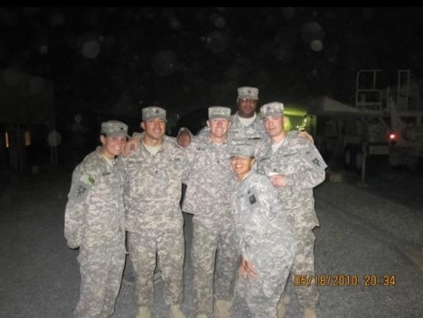 Jen posing in uniform with five of her fellow Army active duty personnel