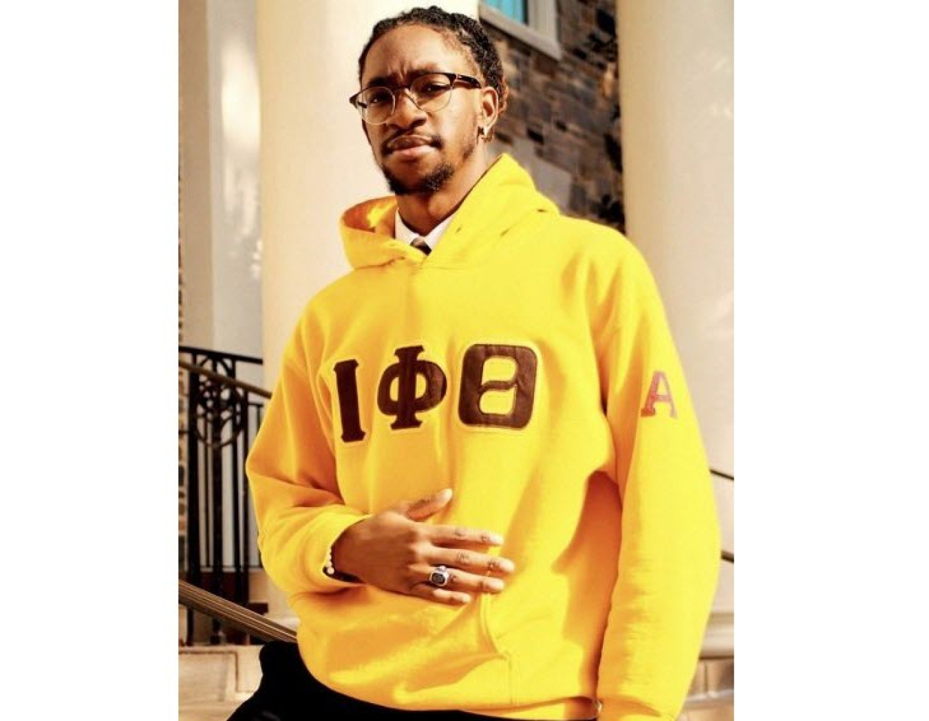 Tyrome Morgan wearing yellow hoodie with Greek letters: Iota Phi Theta