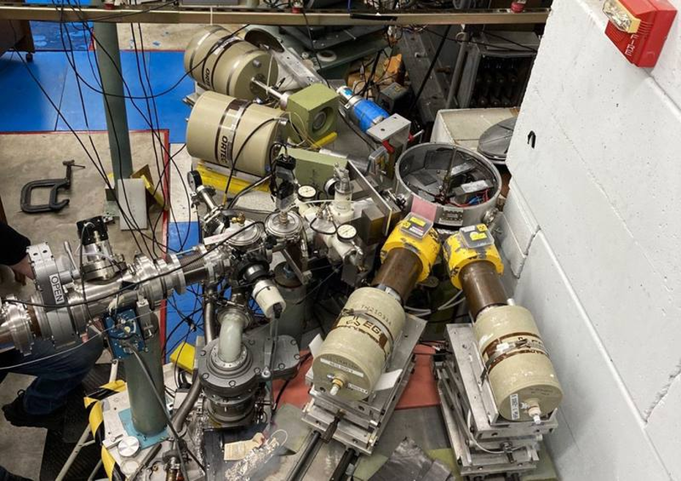 Photo of the experimental setup showing four high-purity germanium detectors surrounding the target chamber at the end of the Triangle Universities Nuclear Laboratory beamline.